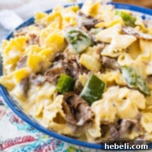 Ultimate Philly Cheesesteak Mac 5 Close-up of a serving of Philly Cheesesteak Mac and Cheese, showcasing the rich, creamy texture and generous fillings.