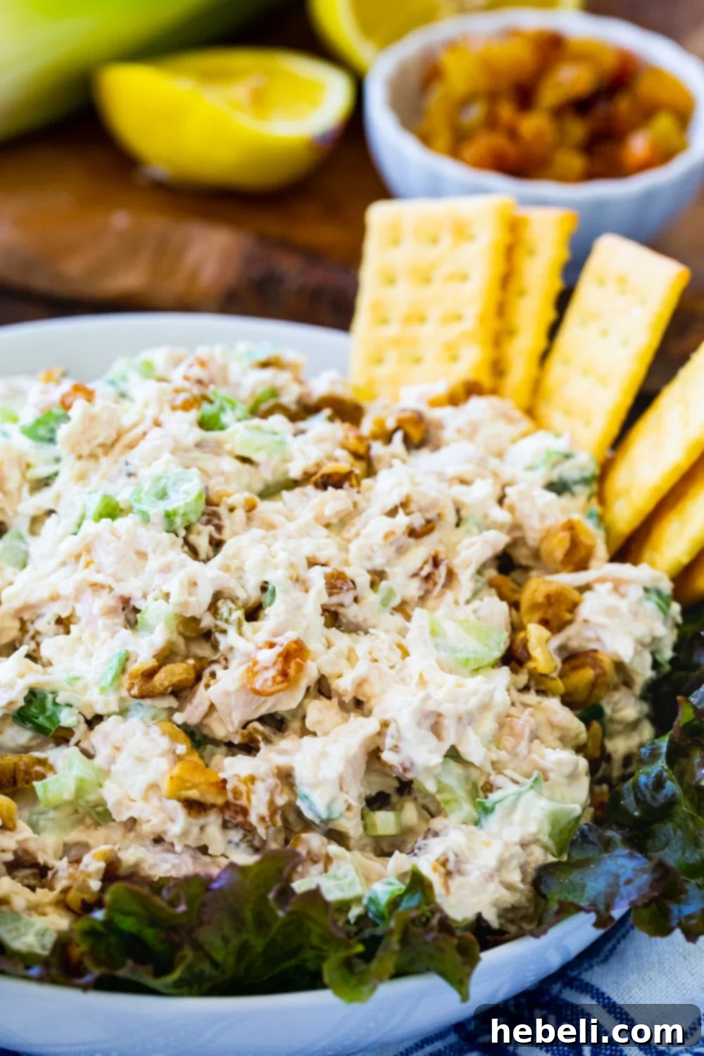 Golden Chicken Salad presented on a crisp bed of fresh lettuce in an elegant serving bowl, ready for a meal.