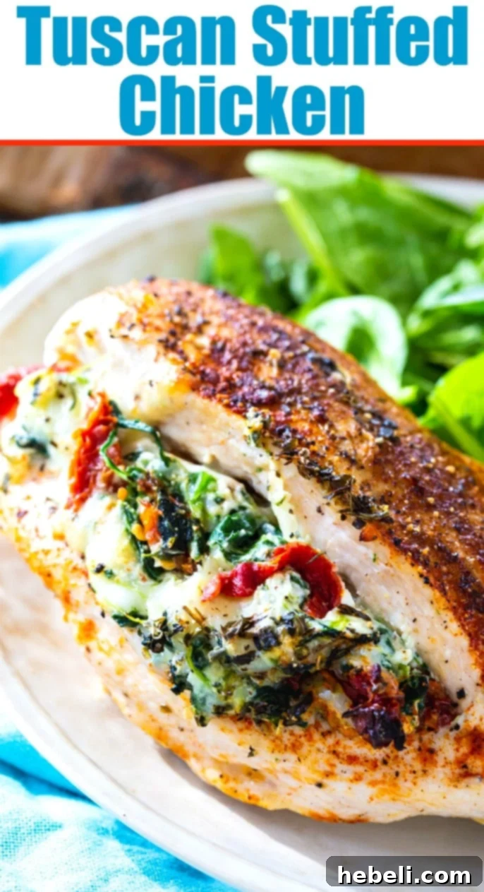 Two pieces of Tuscan Stuffed Chicken beautifully plated, highlighting the golden crust and vibrant filling.