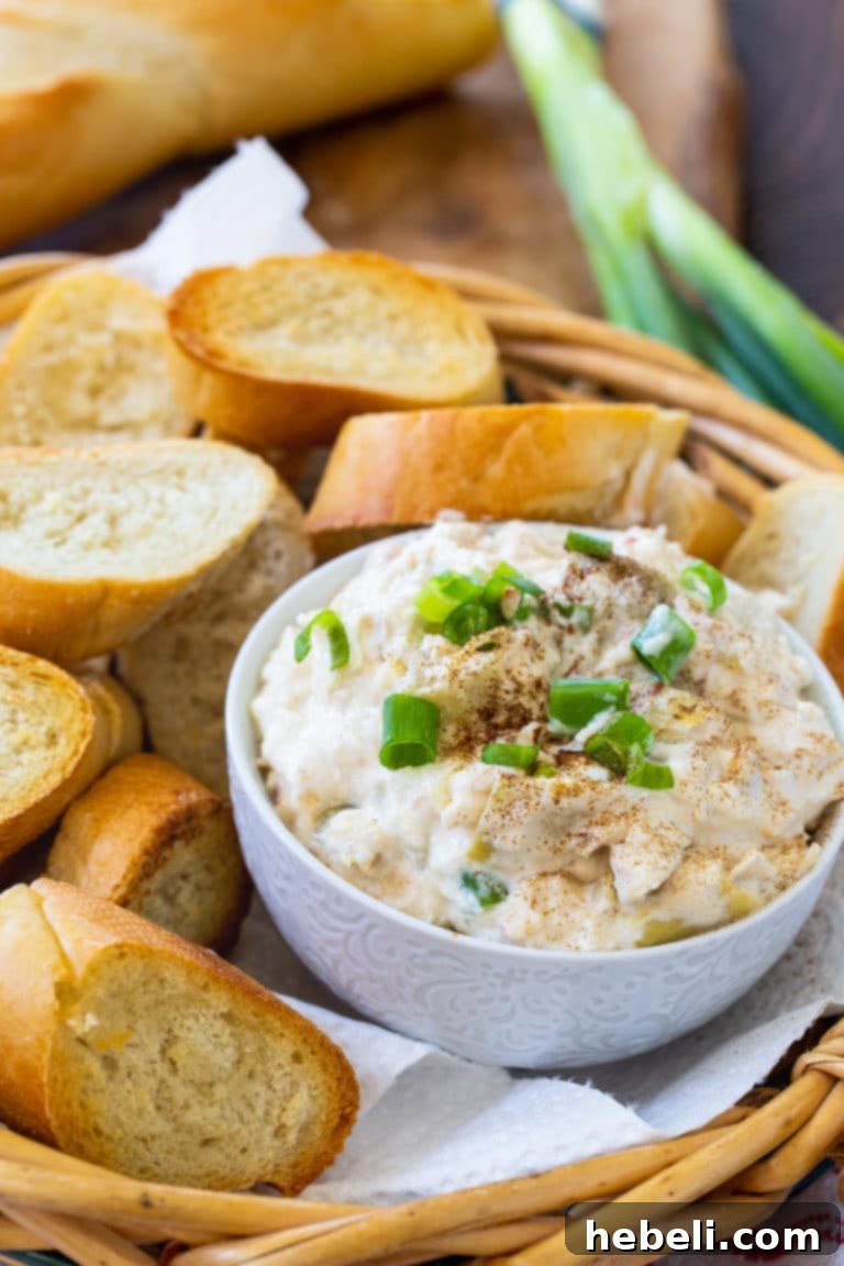 Crock Pot Crab Artichoke Dip 4 Another mouthwatering shot of Crockpot Crab Artichoke Dip, showcasing its golden-brown, bubbly top.