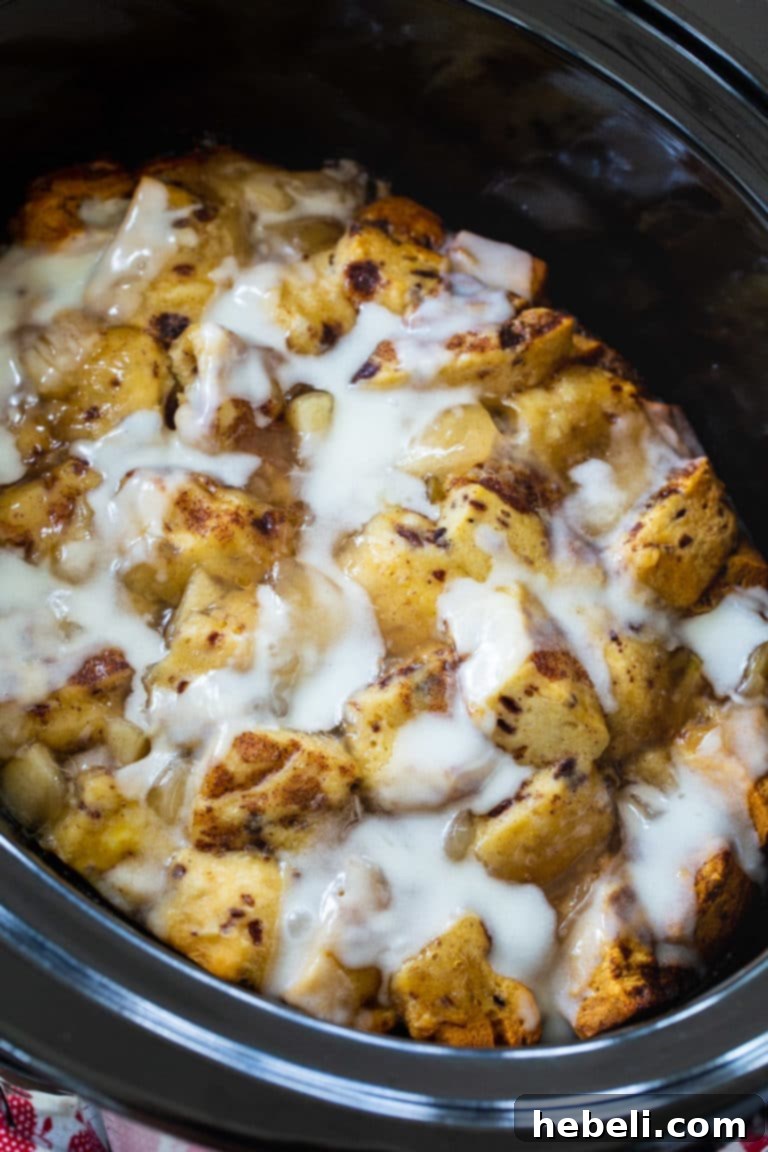 Slow Cooker Apple Pie Cinnamon Roll Bake 3 Close-up of the gooey Crock Pot Apple Pie Cinnamon Roll Casserole, ready to be served