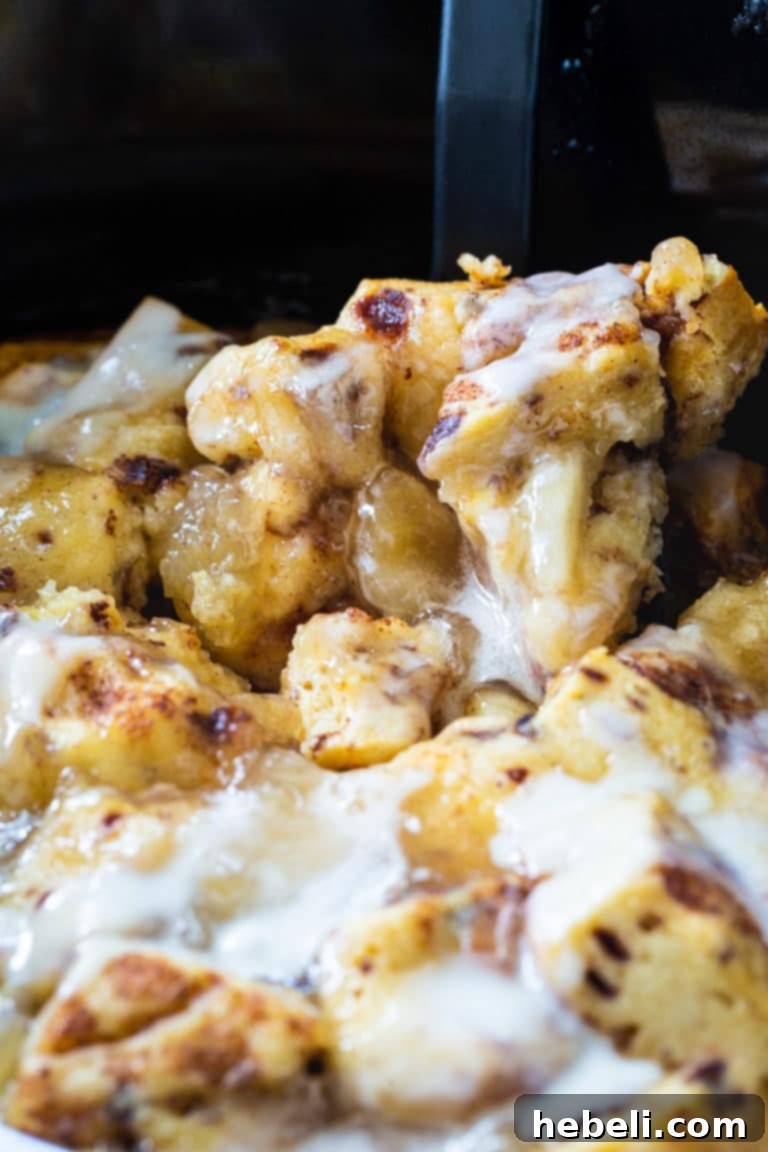 Slow Cooker Apple Pie Cinnamon Roll Bake 4 The finished Crock Pot Apple Pie Cinnamon Roll Casserole with icing, ready to be enjoyed