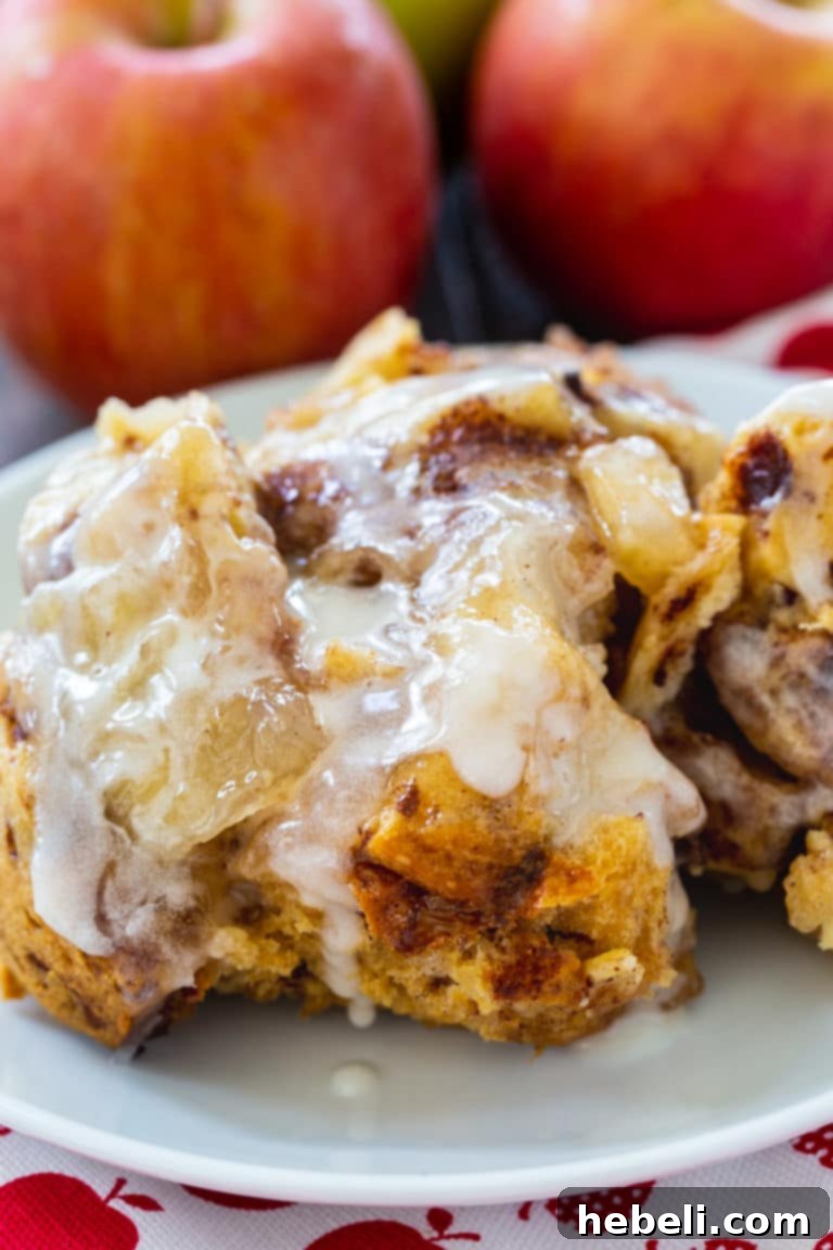 Slow Cooker Apple Pie Cinnamon Roll Bake 5 Stacked slices of Crock Pot Apple Pie Cinnamon Roll Casserole, showcasing its gooey texture