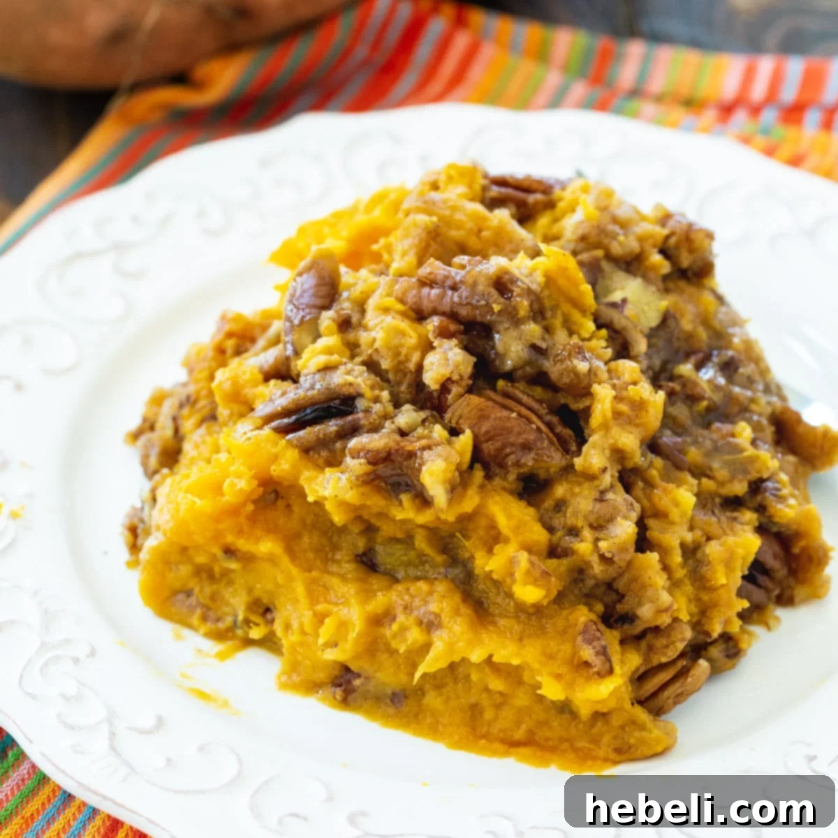Set It and Forget It Sweet Potato Casserole 2 Serving of Crock Pot Sweet Potato Casserole on a plate with crunchy pecans and a hint of brown sugar glaze.