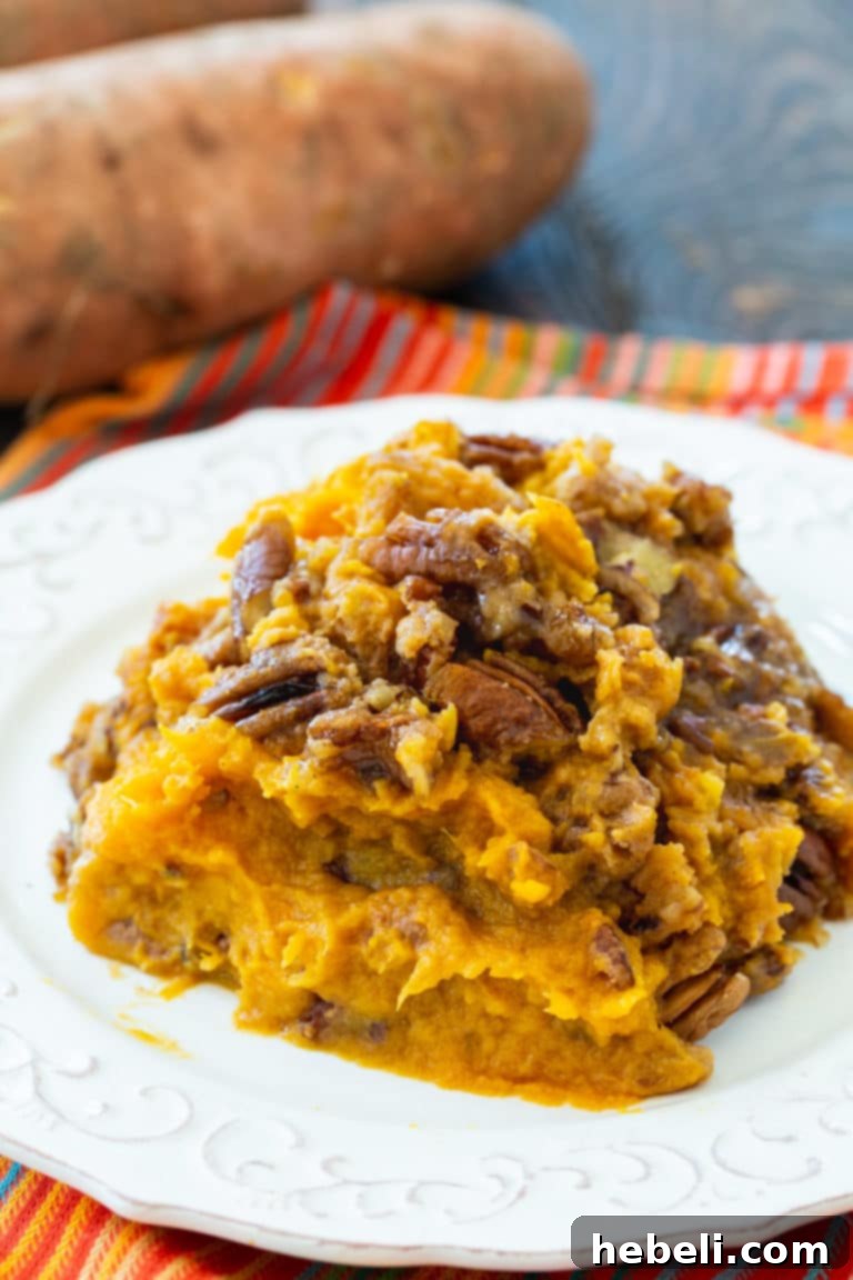 Set It and Forget It Sweet Potato Casserole 4 Beautifully prepared Crock Pot Sweet Potato Casserole with a generous pecan topping, ready to be served.