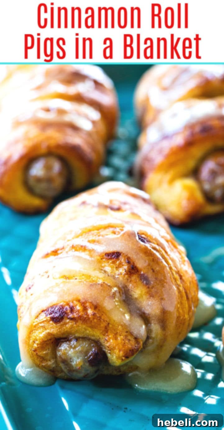 A close-up shot of Cinnamon Roll Pigs in a Blanket, showing the flaky dough and savory sausage.