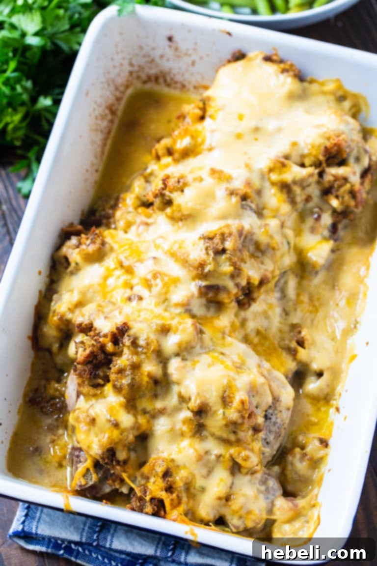 Savory Stuffing-Crusted Pork Chops 3 Close-up of baked Stuffing Topped Pork Chops, showing the moist stuffing and melted cheddar cheese.