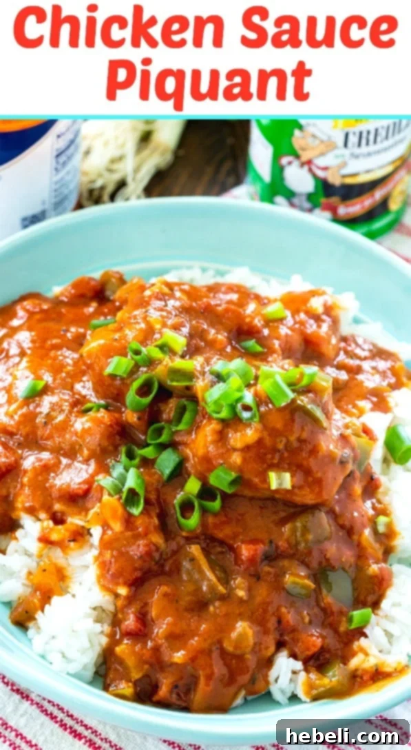 A top-down view of a classic red Dutch oven filled with simmering Chicken Sauce Piquant, perfectly cooked and ready to be served.