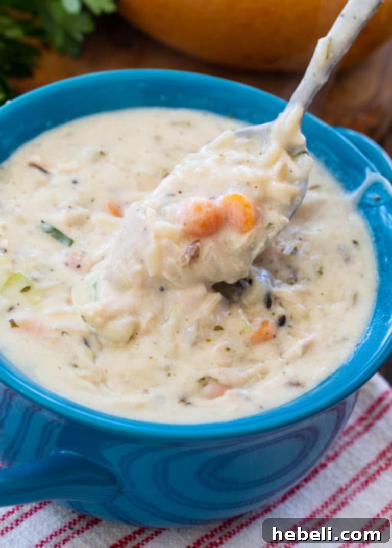 A bowl of Creamy Leftover Turkey Wild Rice Soup with crusty bread
