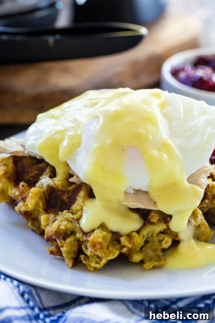 Thanksgiving Eggs Benedict with generous hollandaise sauce over turkey and a stuffing waffle.