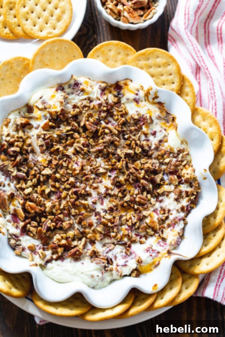 Close-up of the creamy Hot Pecan Beef Dip with a cracker, showing its inviting texture.