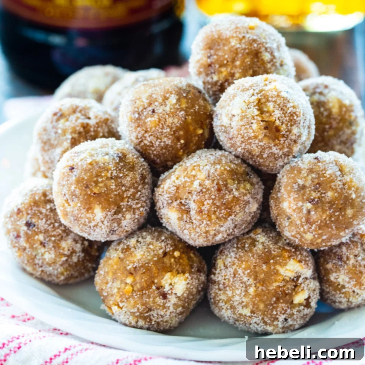 A festive plate piled high with Classic Rum Balls, dusted with sugar and ready to be enjoyed.
