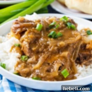 Slow Cooker Smothered Pork Chops served over white rice