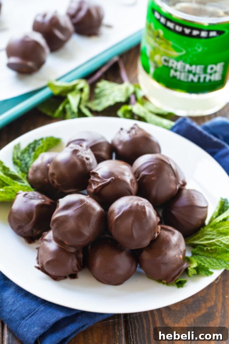 Velvet Mint Truffles 3 Creme de Menthe Truffles fully covered in a smooth, dark chocolate coating, ready to be enjoyed.