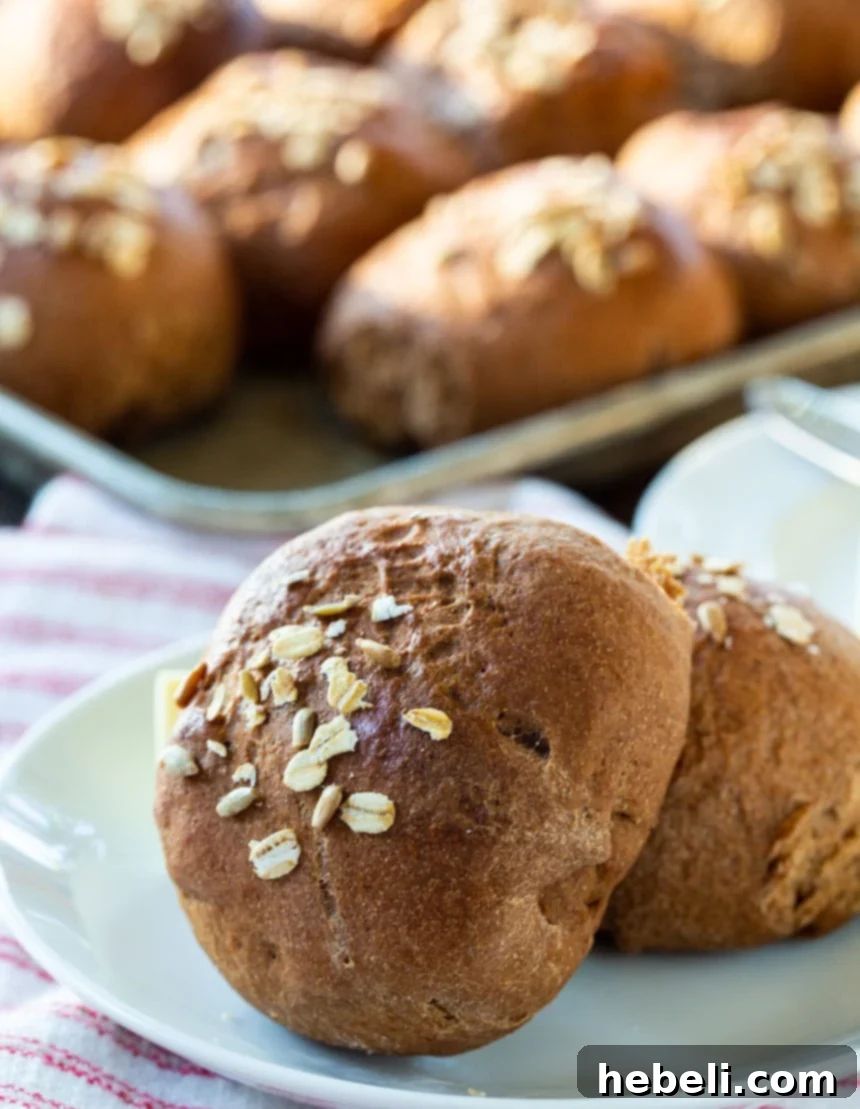 A basket full of freshly baked Whole Wheat Molasses Rolls, ready to be served.