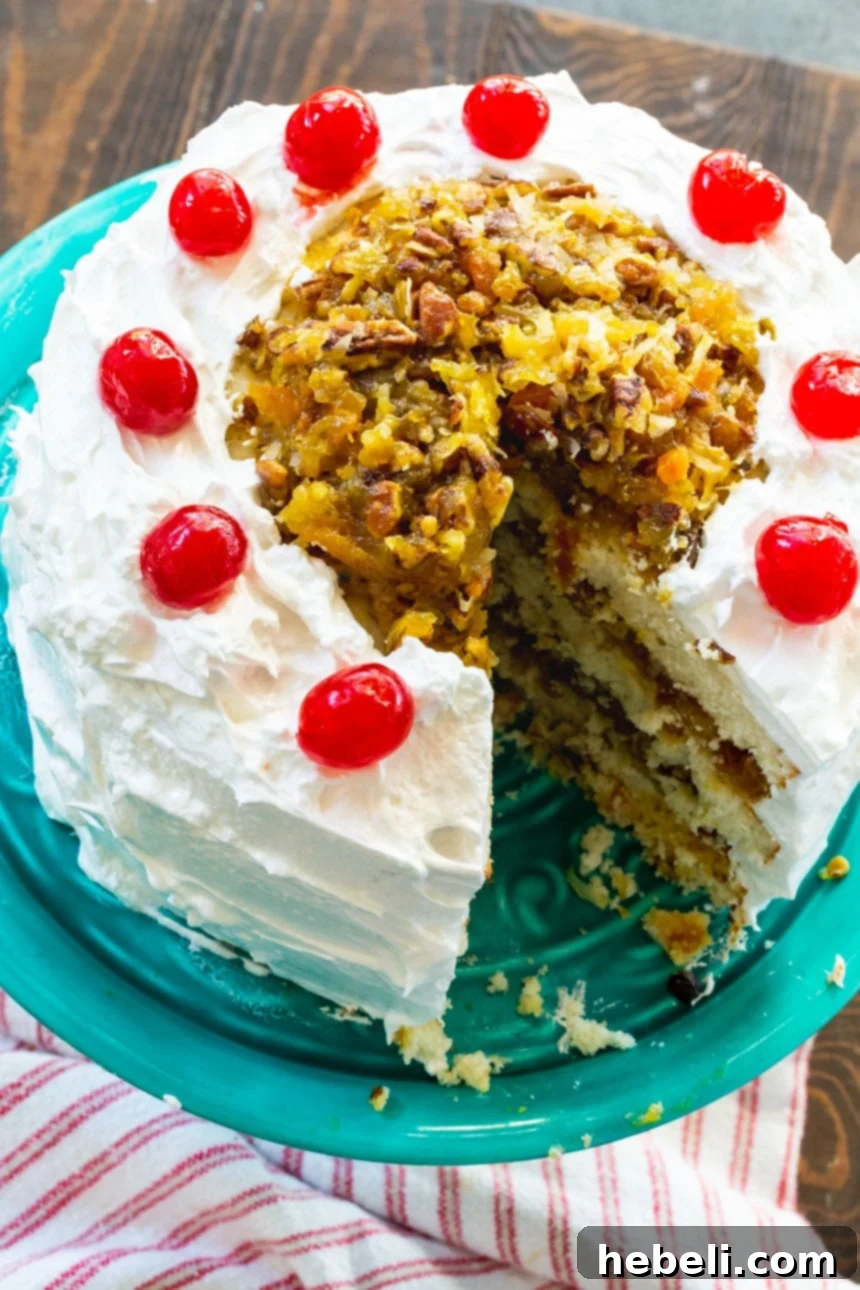 Close-up of a delectable slice of Southern Lane Cake, revealing its moist white cake layers, rich bourbon-infused fruit and nut filling, and smooth frosting.