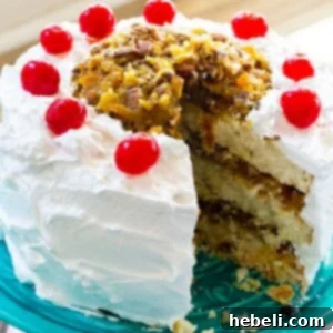 A stunning Lane Cake with 7-Minute Frosting, beautifully sliced and ready for serving.