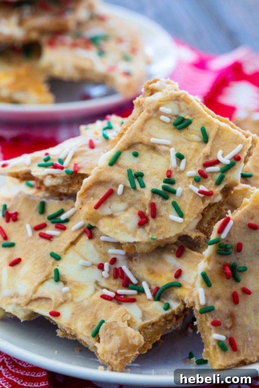Decadent White Chocolate Peanut Butter Christmas Crack 4 The process of making White Chocolate and Peanut Butter Christmas Crack, showing the melted white chocolate being spread.