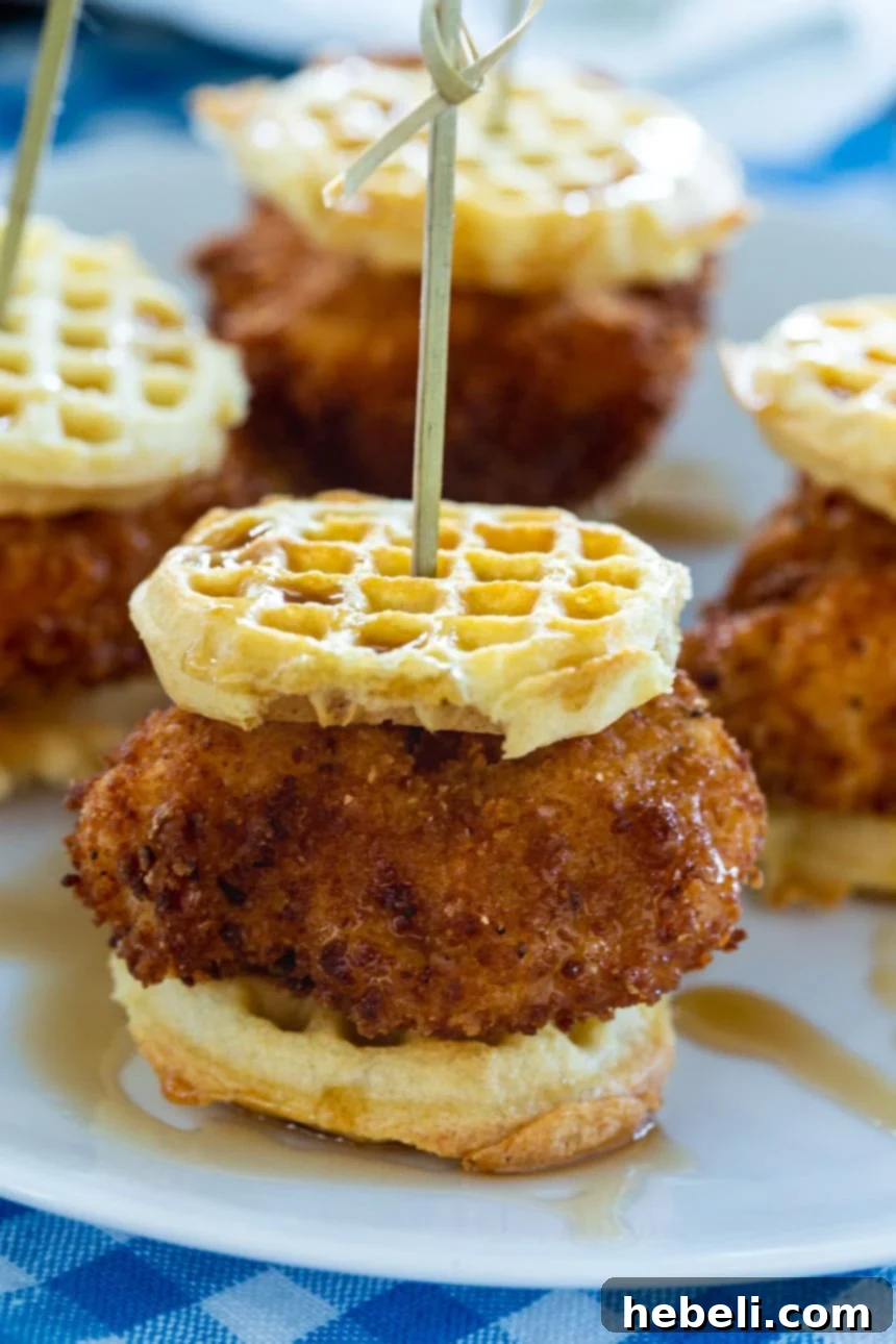A close-up of Chicken and Waffle Sliders stacked elegantly, showcasing their golden-brown perfection.