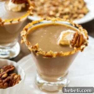 Martini in a glass with chopped pecans around rim.