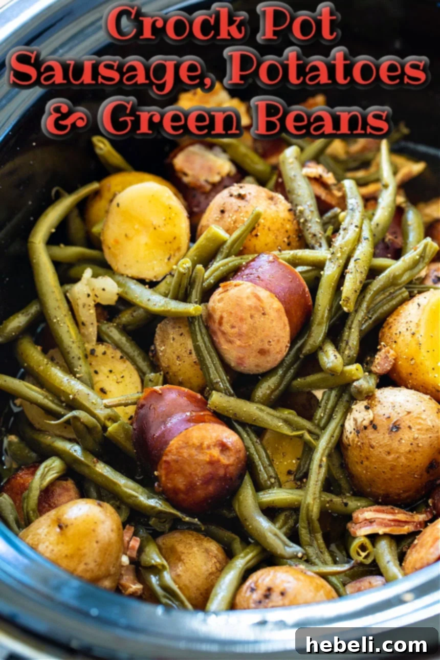 A serving of Crock Pot Sausage, Potatoes, and Green Beans in a bowl, fresh from the slow cooker.