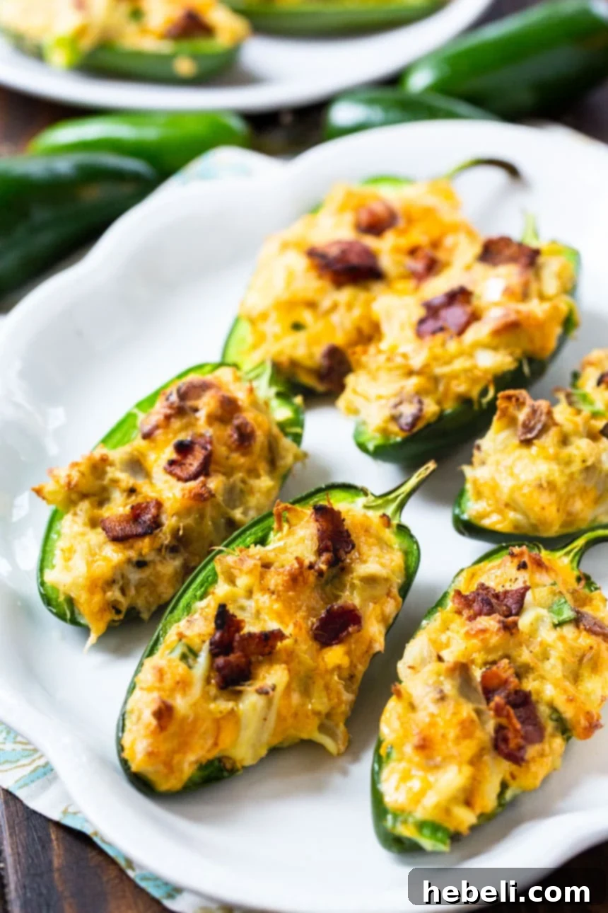 A baking tray filled with freshly baked Cajun Crab Stuffed Jalapenos, ready to be served as an appetizer.