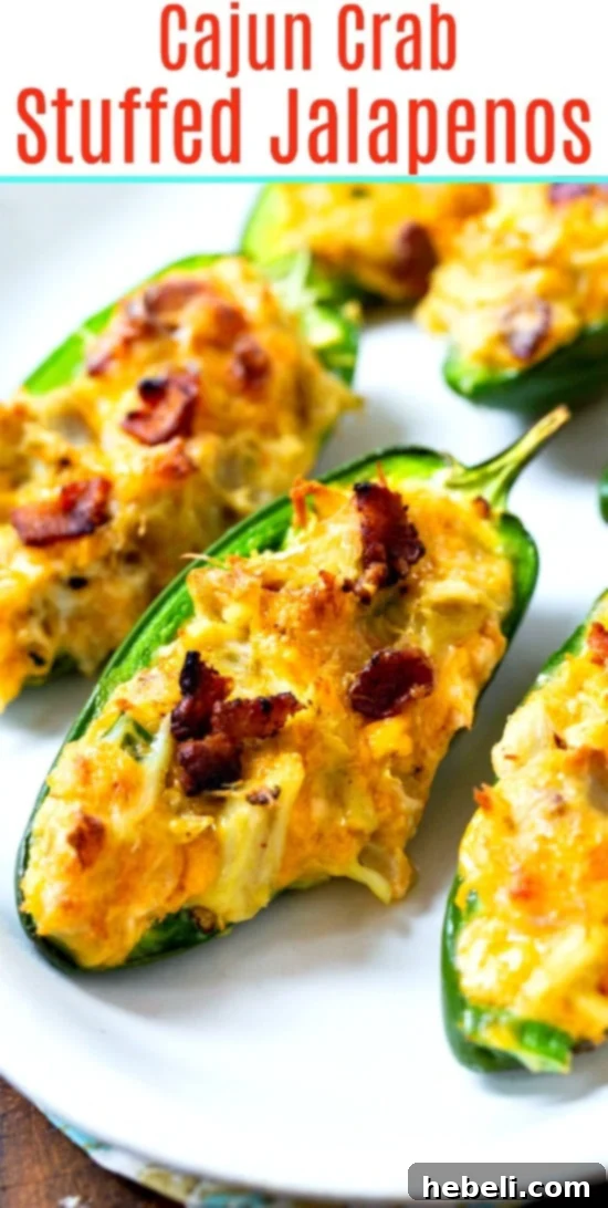 A close-up of a single Cajun Crab Stuffed Jalapeno, showing the perfectly baked, golden-brown top and creamy filling.