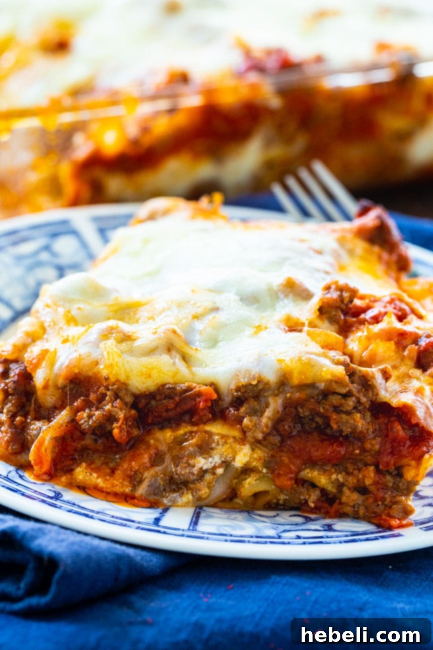 A large baking dish filled with Easy Make-Ahead Lasagna, freshly baked with golden, bubbly cheese on top.