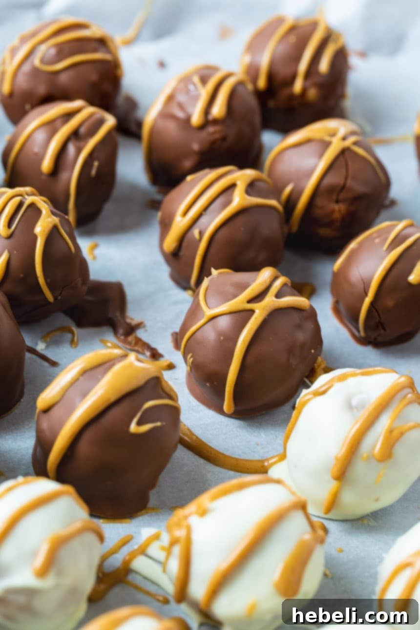 Nutterly Delicious Truffle Bites 3 A selection of Nutter Butter Truffles, some covered in white chocolate and others in milk chocolate, showcasing their inviting appearance.