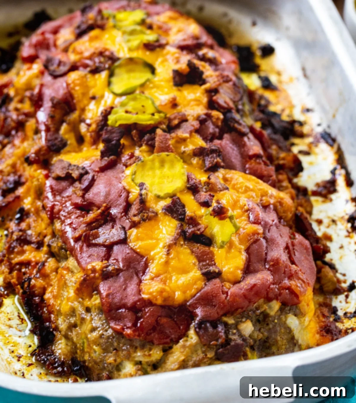 Loaded Bacon Cheeseburger Meatloaf 2 Hearty Bacon Cheeseburger Meatloaf in a roasting pan, ready to be served.