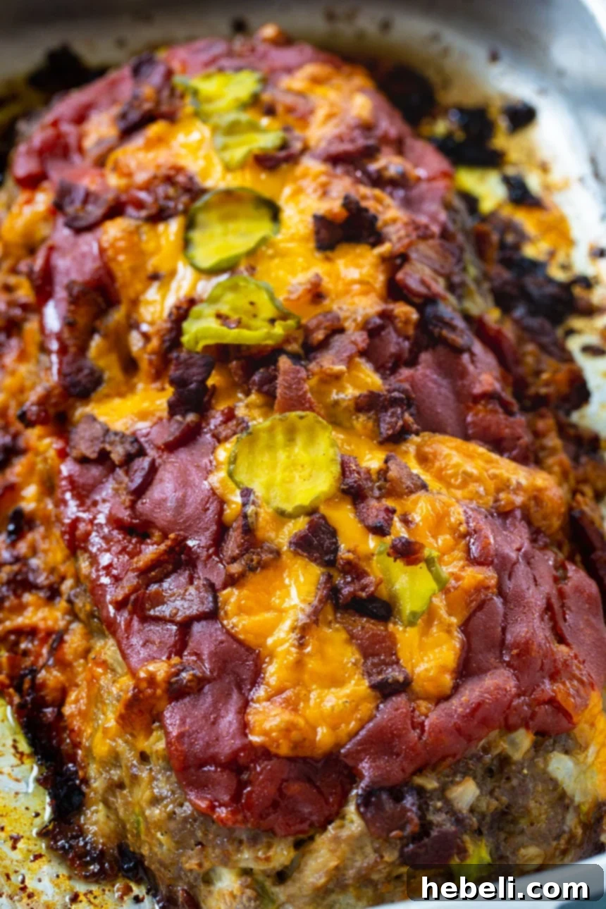 Loaded Bacon Cheeseburger Meatloaf 4 Close-up of a slice of Bacon Cheeseburger Meatloaf, showing the bacon, cheese, and moist texture.