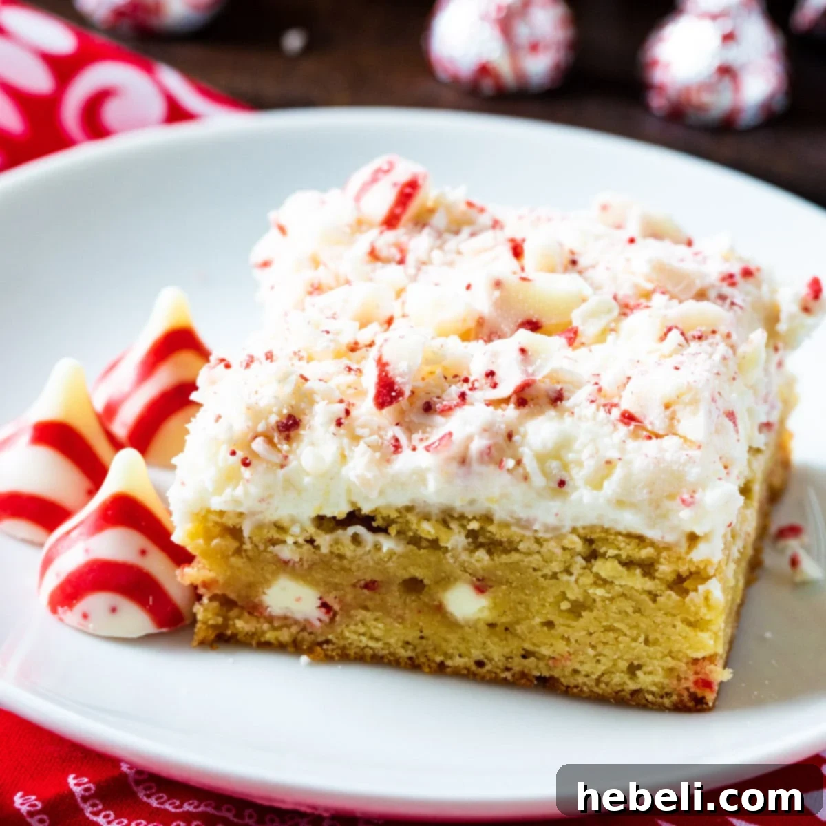 A single peppermint blondie with creamy buttercream on a white plate, ready to be enjoyed.