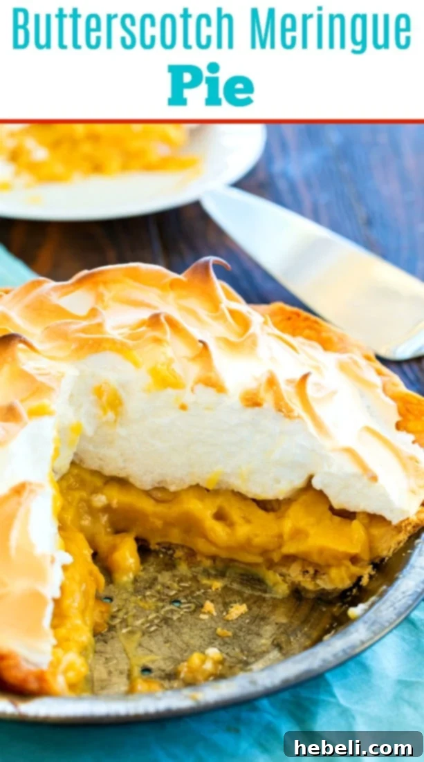 Another beautiful shot of the Old-Fashioned Butterscotch Meringue Pie, emphasizing its tall, perfectly browned meringue and golden crust.