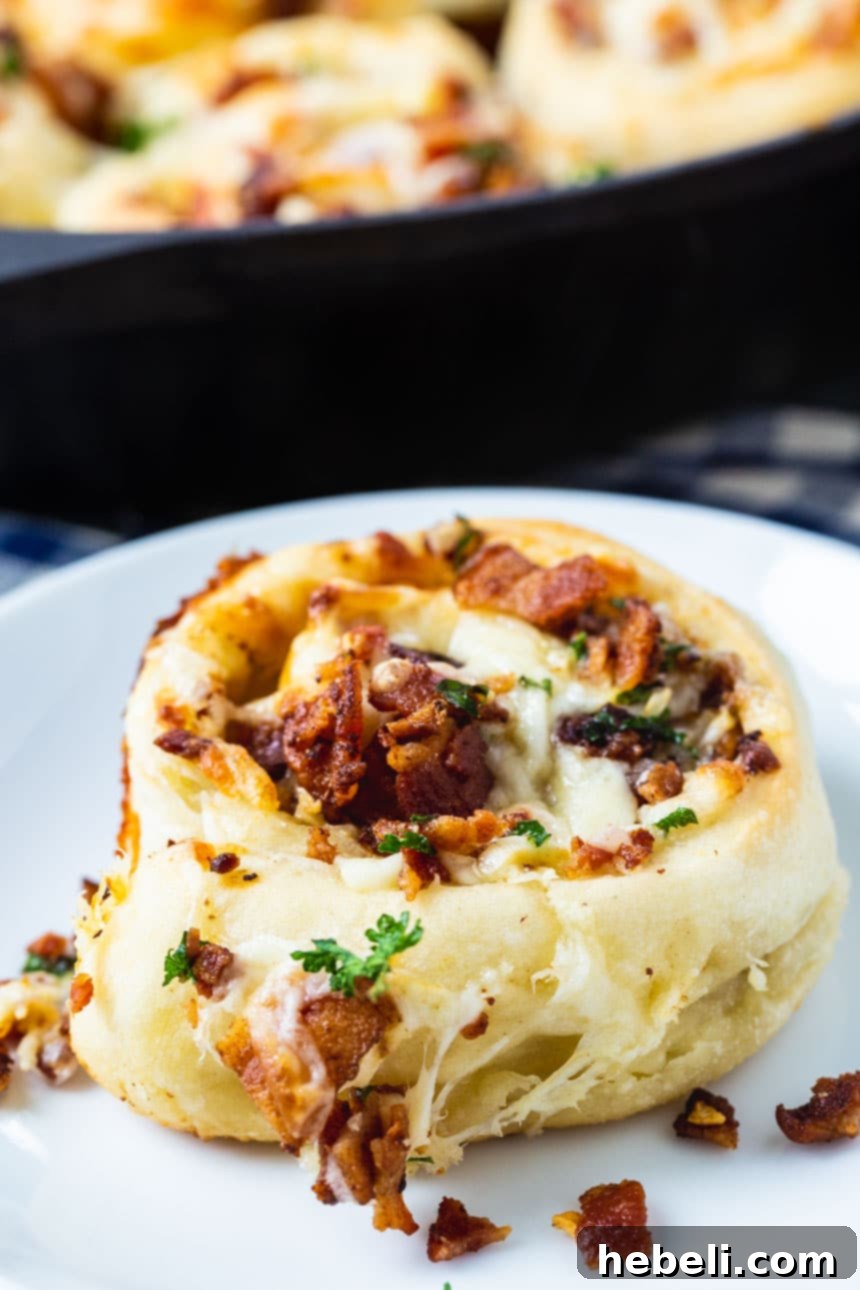 Close-up of baked Bacon Stuffed Cheesy Garlic Rolls, showing the crispy edges, melted gooey cheese, and bits of bacon and garlic.