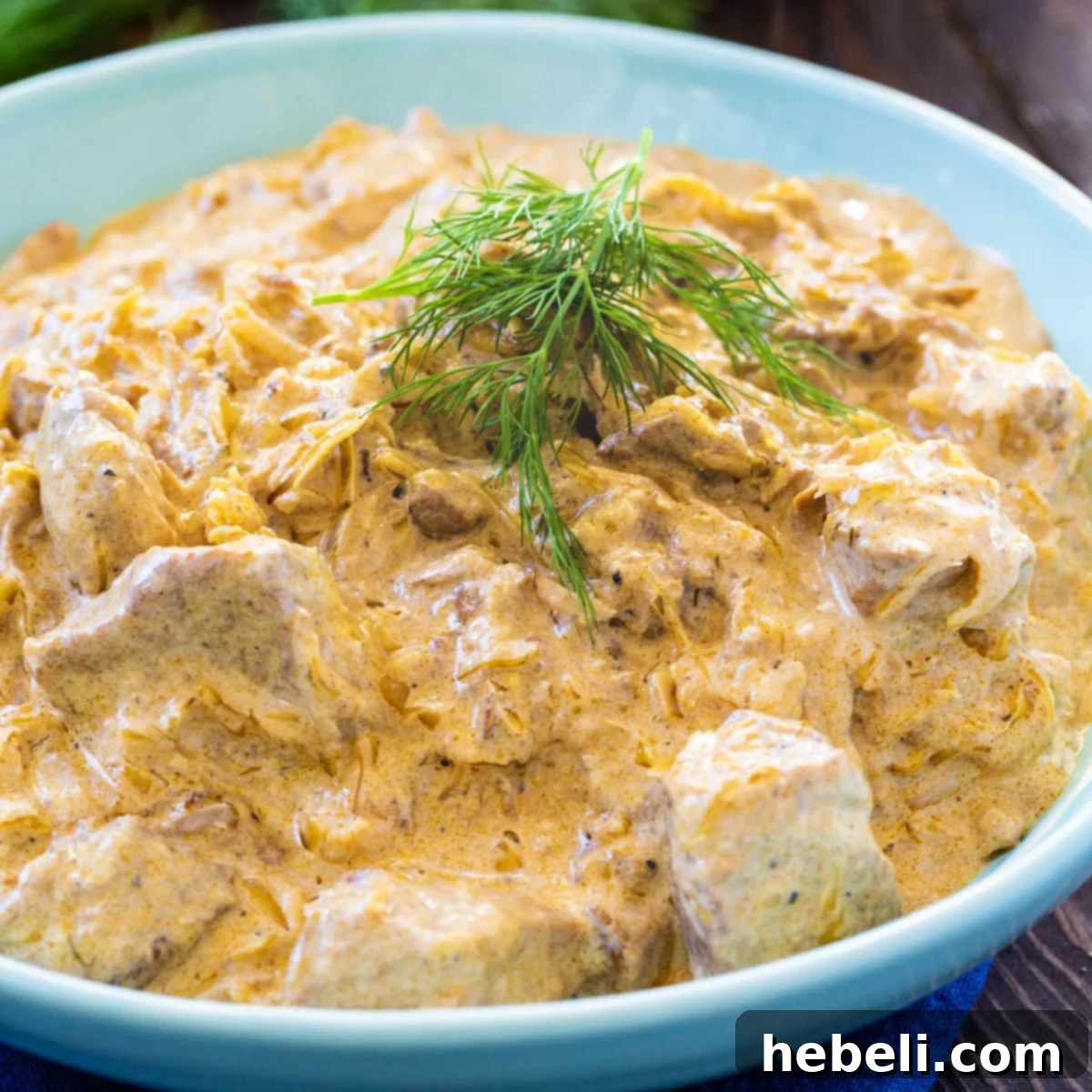 Hungarian Pork Goulash 2 A vibrant bowl of Hungarian Pork Stew, generously topped with fresh dill, ready to be enjoyed.