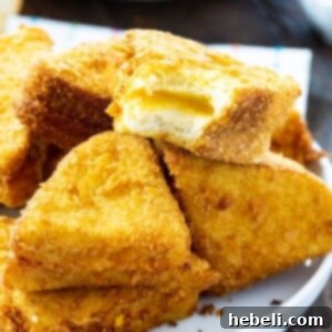 Recipe image for Cheese Frenchies, showing a perfect golden-brown deep-fried grilled cheese sandwich.