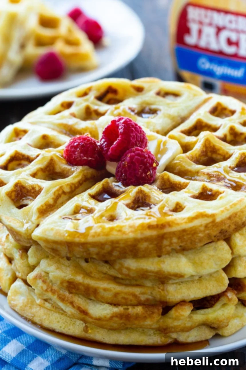 Close-up shot of a single Overnight Yeast Waffle, showcasing its golden-brown color and crispy texture, ready to be topped.