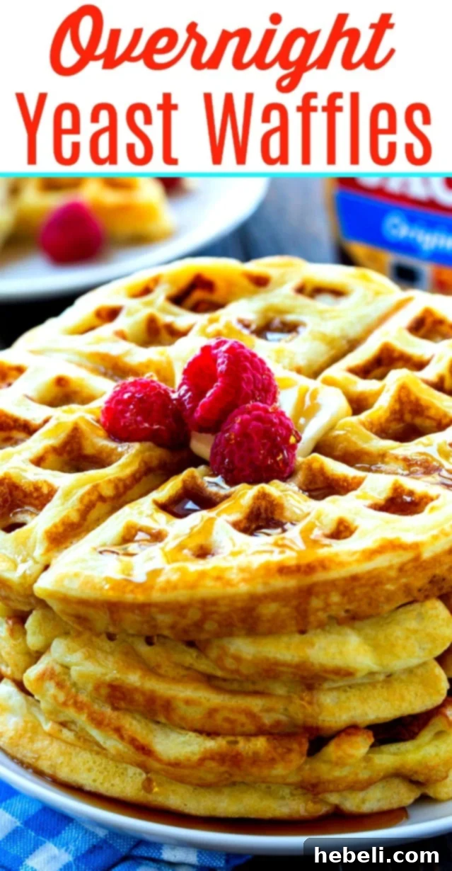 A stack of three golden brown Overnight Yeast Waffles, perfectly cooked and ready to be enjoyed.