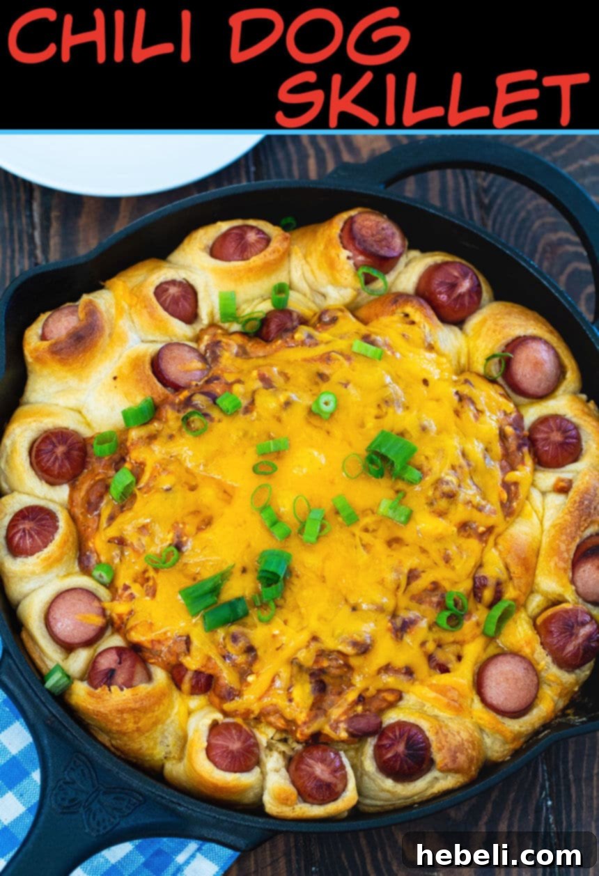 Close-up of the cooked Chili Dog Skillet in a cast iron skillet, garnished with green onions.