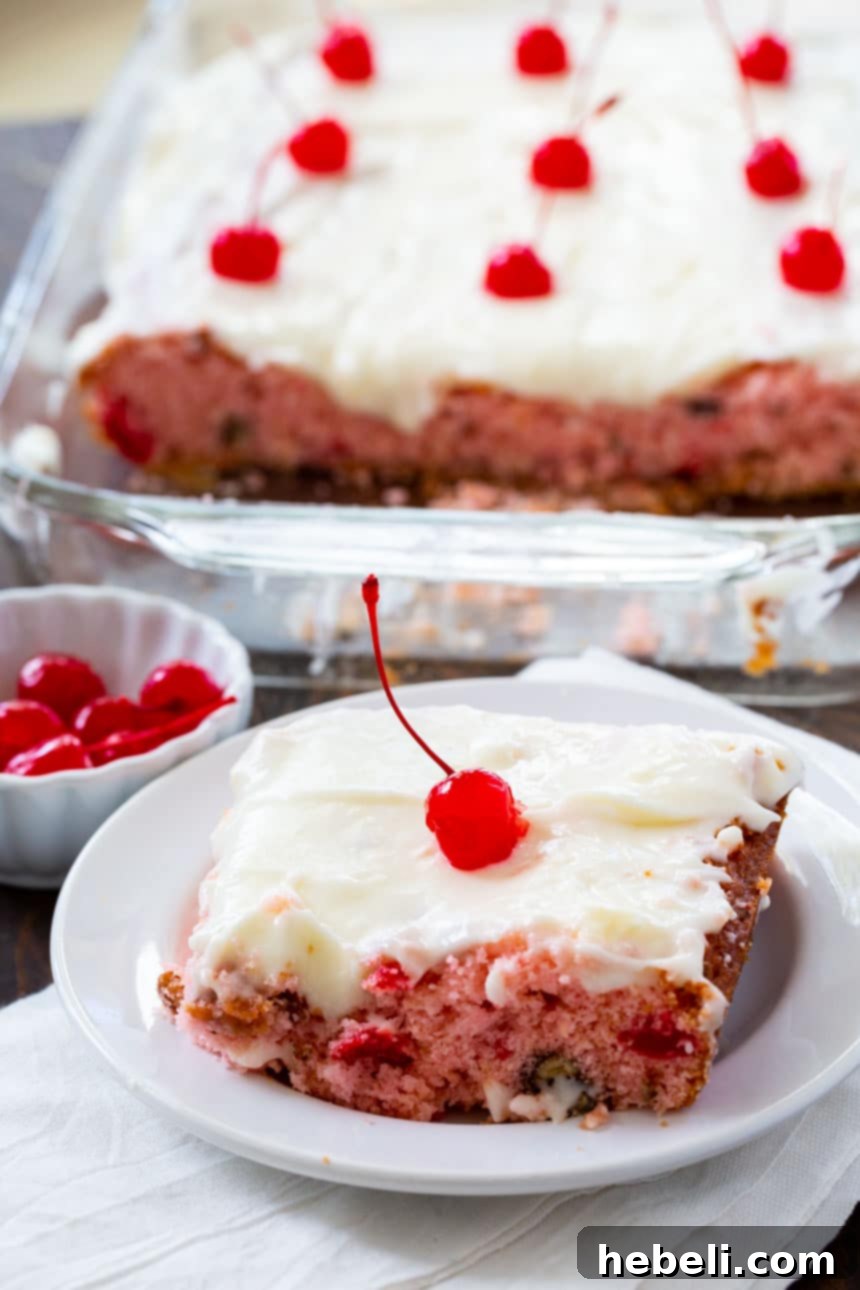A freshly baked Cherry Sheet Cake cooling in a 9x13-inch pan, with a golden-brown edge and a soft, risen center, ready for frosting.
