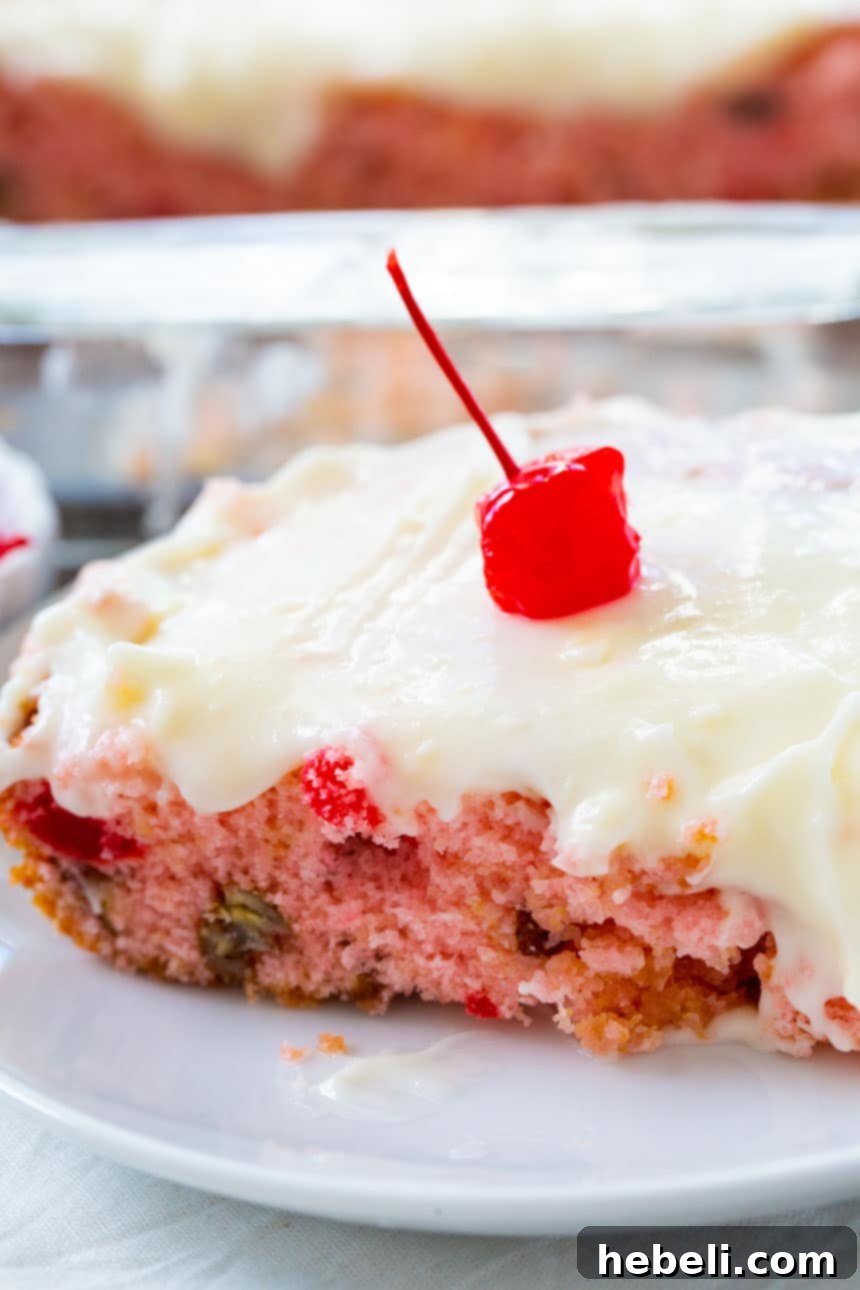 A close-up view of the smooth, white almond-flavored cream cheese icing spread generously over the Cherry Sheet Cake, ready for garnishing.