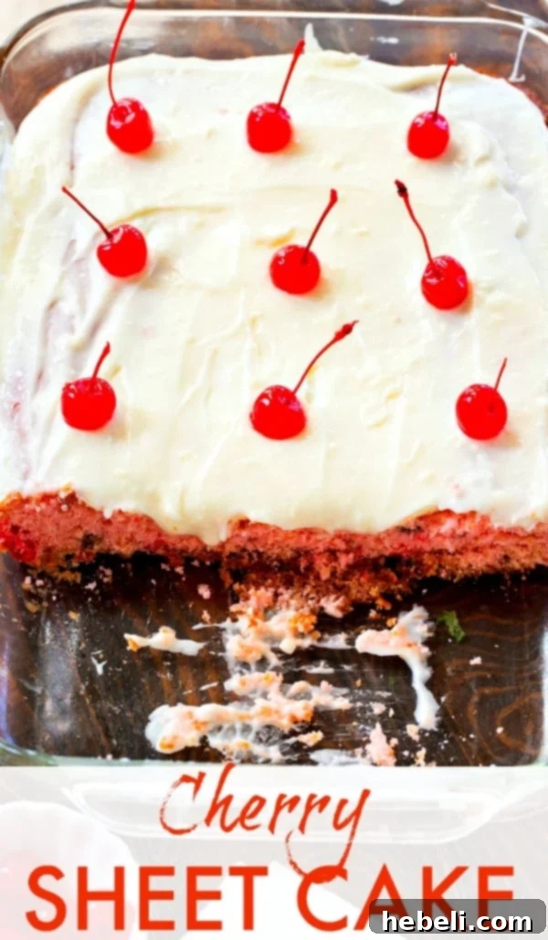 A stunning overhead shot of the full Cherry Almond Sheet Cake, beautifully frosted and garnished with whole maraschino cherries, presented in its pan.