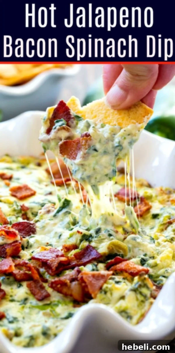 Fiery Jalapeno Bacon Spinach Dip 6 A generously sized serving of Hot Jalapeno Bacon Spinach Dip in a white baking dish, garnished with fresh herbs.