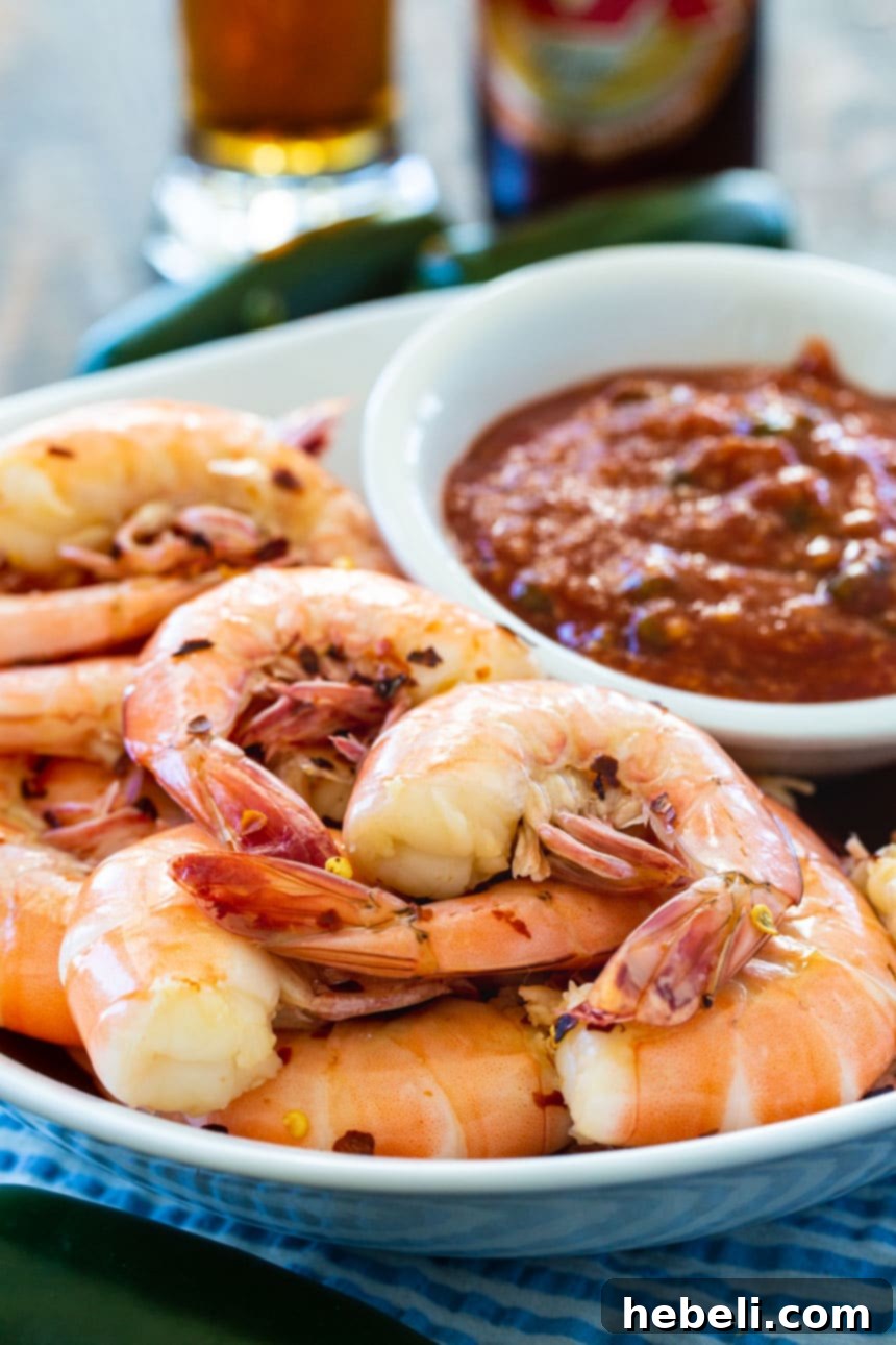 Drunken Shrimp with Fire Roasted Jalapeno Kick 4 A close-up shot of Drunken Shrimp being peeled, highlighting the perfect texture and inviting presentation.