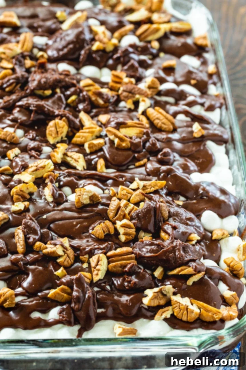 Mixing the rich, dark chocolate cake batter for Southern Mississippi Mud Cake in a large bowl with a hand-held electric mixer.