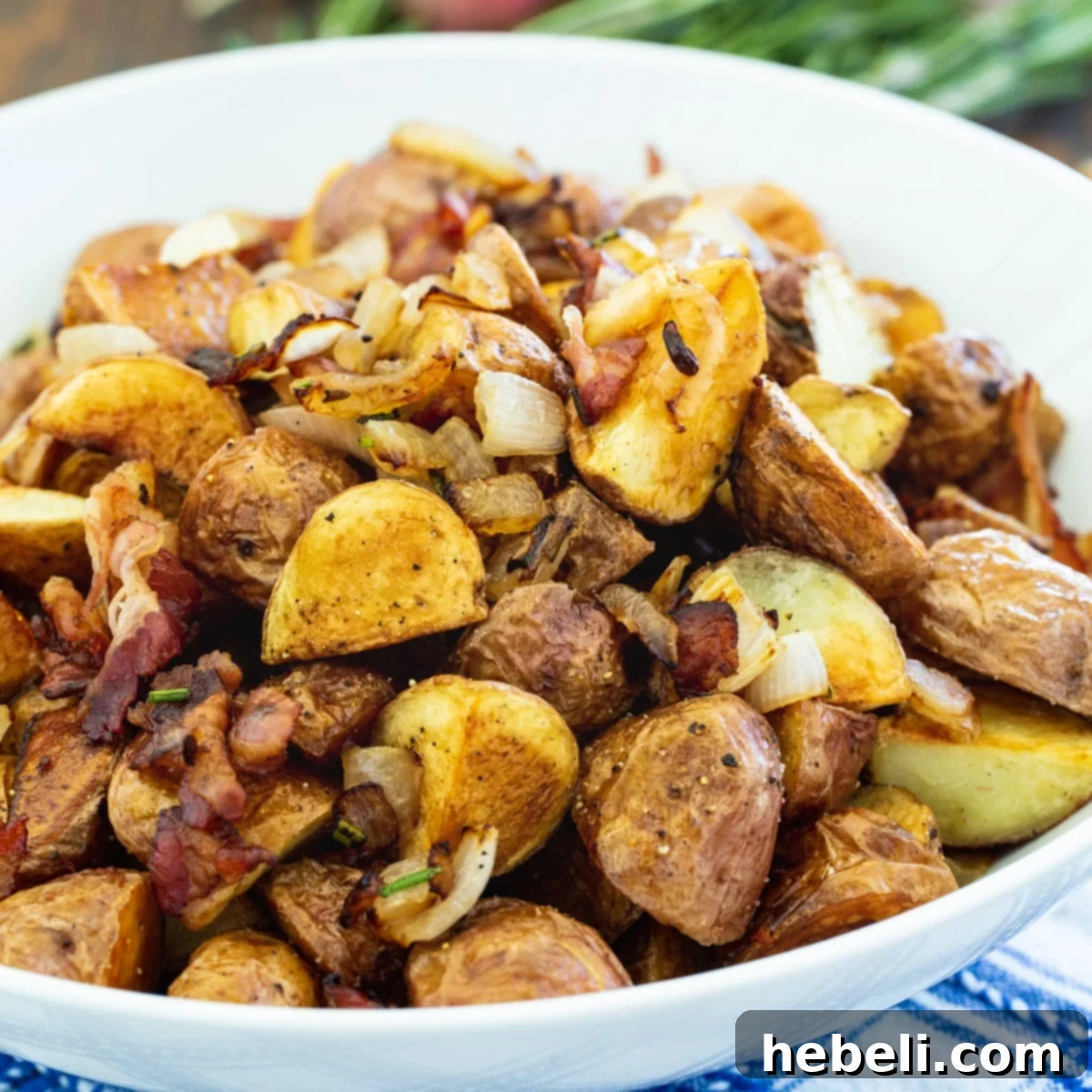 A serving of Italian Roasted Potatoes with crispy edges and visible pancetta and rosemary.