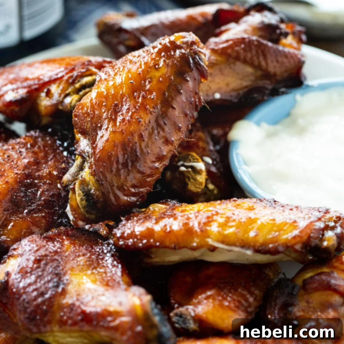 Perfectly glazed Sticky Soy Chicken Wings on a serving plate, ready to be enjoyed with a side of dipping sauce.
