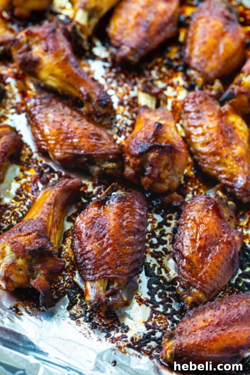 Close-up of baked Sticky Soy Chicken Wings glistening with their rich, caramelized glaze.