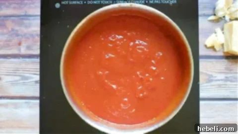 Rich tomato sauce for the Italian Meatloaf being prepared in a saucepan.