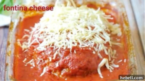 Melted Fontina cheese bubbling on top of Italian Meatloaf after broiling.